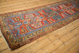 Antique Northwest Persian runner's brick red field, serrated medallion, and starburst border design.