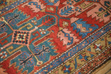 Antique Persian runner's sapphire geometric border and brick red field with blush leaves.
