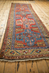 Northwest Persian runner detail showcasing sapphire geometric border and brick red serrated leaves.