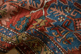 Varied pile texture of an antique Northwest Persian rug with serrated brick red and sapphire blue motifs.