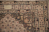 Distressed antique Kerman rug border, featuring faded patterned blossoms and worn texture.