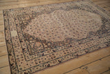 Antique Kerman rug border with blush florals, subtle tone-on-tone contrast, and signature cartouche.