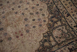 Distressed Kerman rug border with tone-on-tone leopard print pattern and faded floral field.