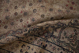Distressed Kerman rug, showing faded field with thousand flower design and patterned border blossoms.