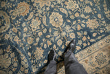 Distressed vintage Yezd carpet showing cobalt blue field, ivory palmettes, and delicate vines.