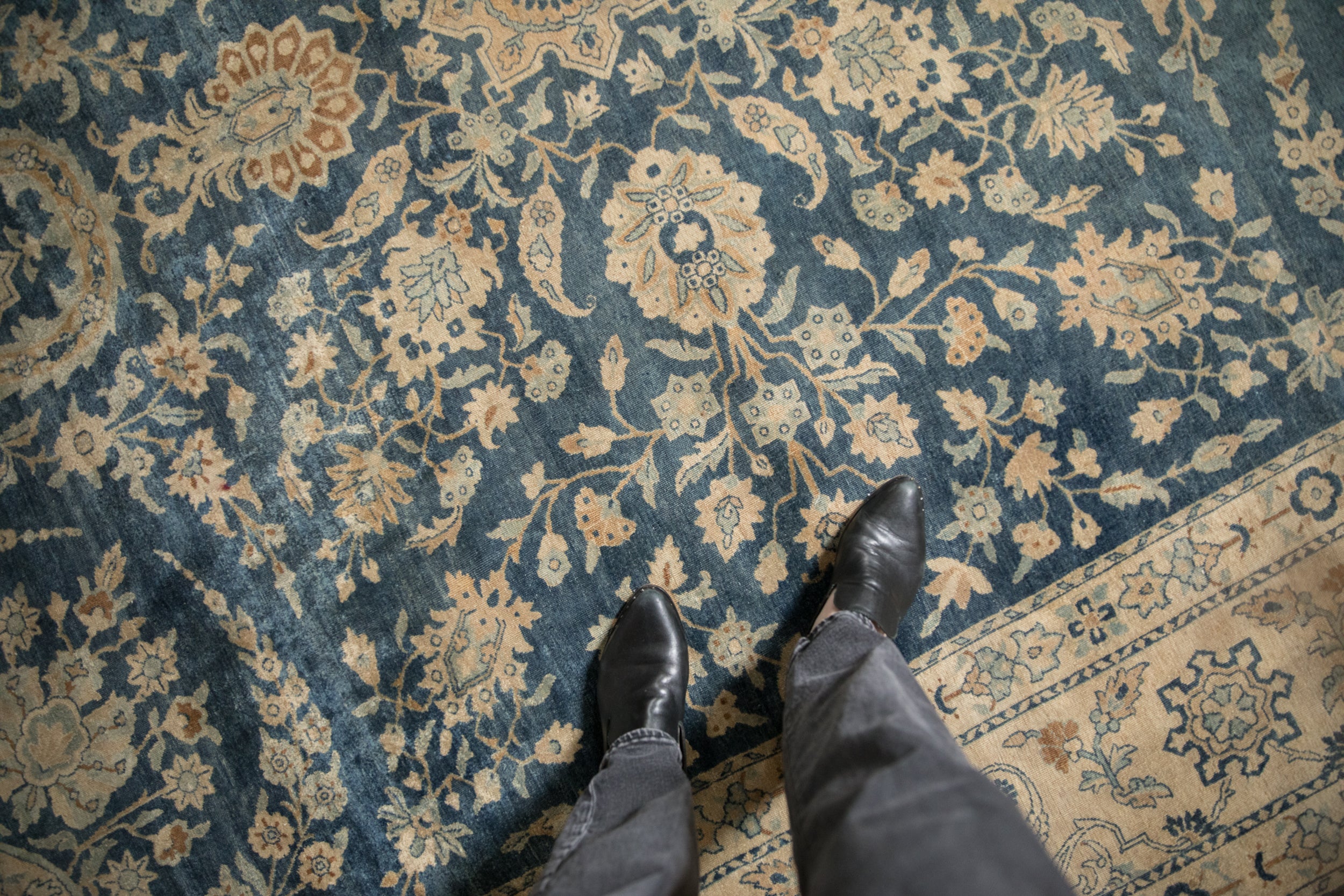 Distressed vintage Yezd carpet showing cobalt blue field, ivory palmettes, and delicate vines.