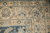 Distressed Yezd carpet corner: ivory ground with cobalt blue floral palmettes and soft texture.