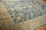 Distressed cobalt blue field with floral palmettes beside the ivory border.