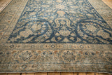 Distressed vintage rug border featuring beige, cobalt blue, and pale coffee floral patterns.