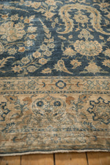 Distressed Yezd carpet's cobalt blue field and ivory border with delicate floral vines.