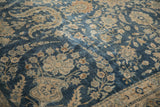 Detail of distressed Yezd carpet, faded cobalt blue and ivory floral and vine motifs, mostly even wear.