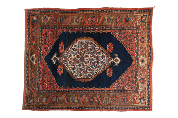 Antique Persian Bijar rug: ivory floral medallion, cobalt blue field, Herati spandrels, turtle samovar border.