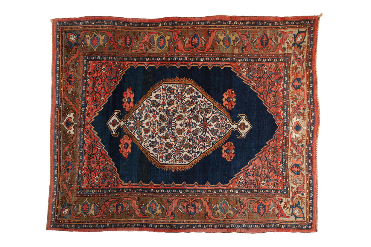 Antique Persian Bijar rug: ivory floral medallion, cobalt blue field, Herati spandrels, turtle samovar border.