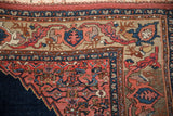 Antique Bijar rug corner: blue turtle samovar border, deer head, coral Herati spandrel.