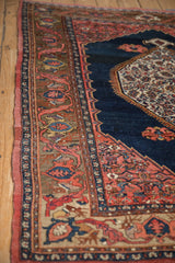 Antique Bijar rug's mythological deer head border, lightning spandrel, and rich cobalt blue.