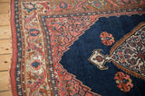 Antique Bijar rug: cobalt blue field, intricate floral motif, and lightning serrated blush spandrel.