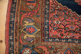 Antique Bijar rug detail: blush and cobalt border with deer head and serrated spandrel.