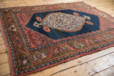 Antique Bijar rug detail: deer head, turtle samovar motifs on coffee brown border.