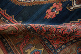 Curled antique Bijar rug edge, highlighting blue field, lightning spandrel, and complex border.