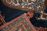 Collector antique Bijar rug pile, blush floral motifs, cobalt blue, and macrame selvage.