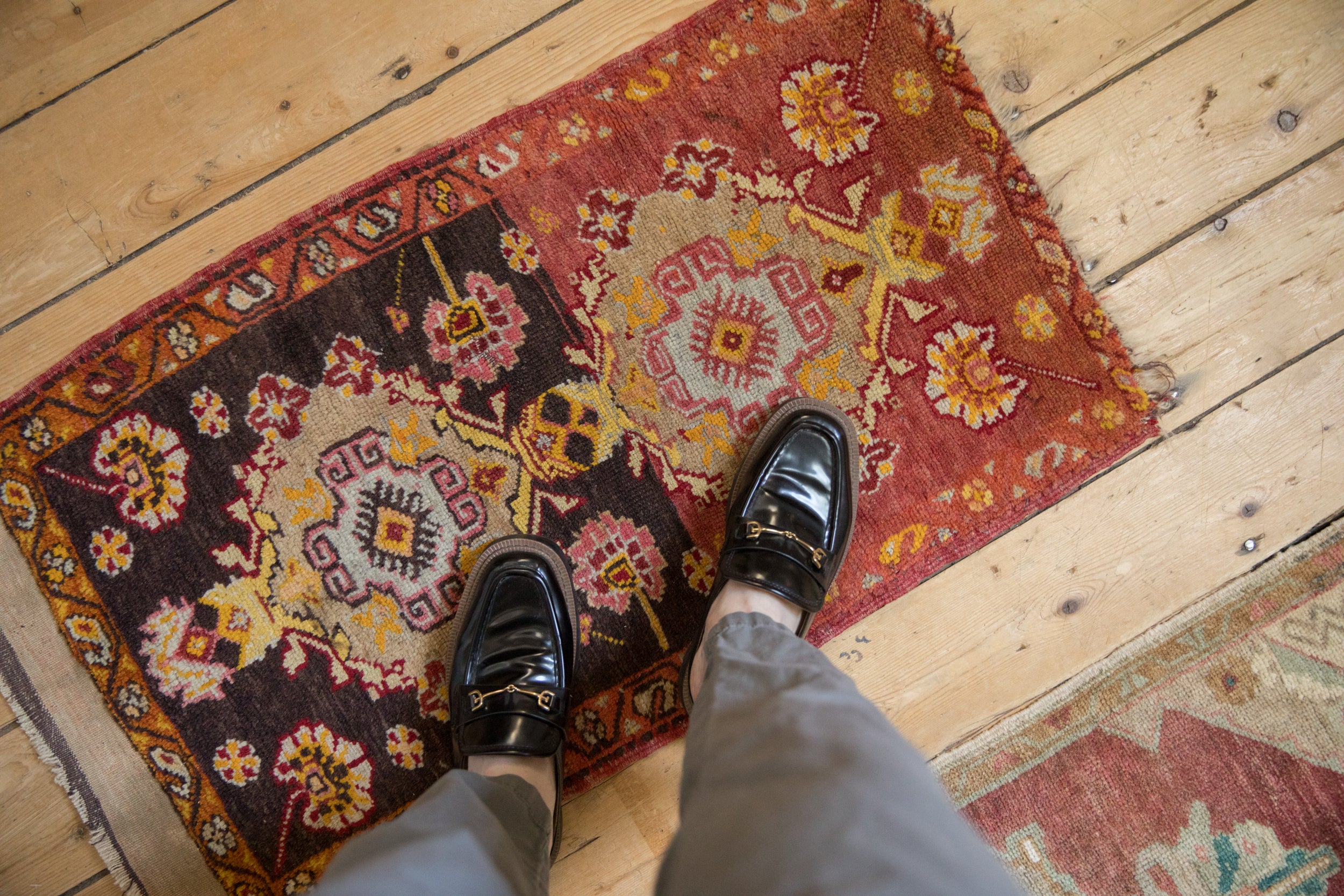 Antique Anatolian rug with quatrefoil medallions, blossoms, and meandering border in deep purple, red, and yellow.