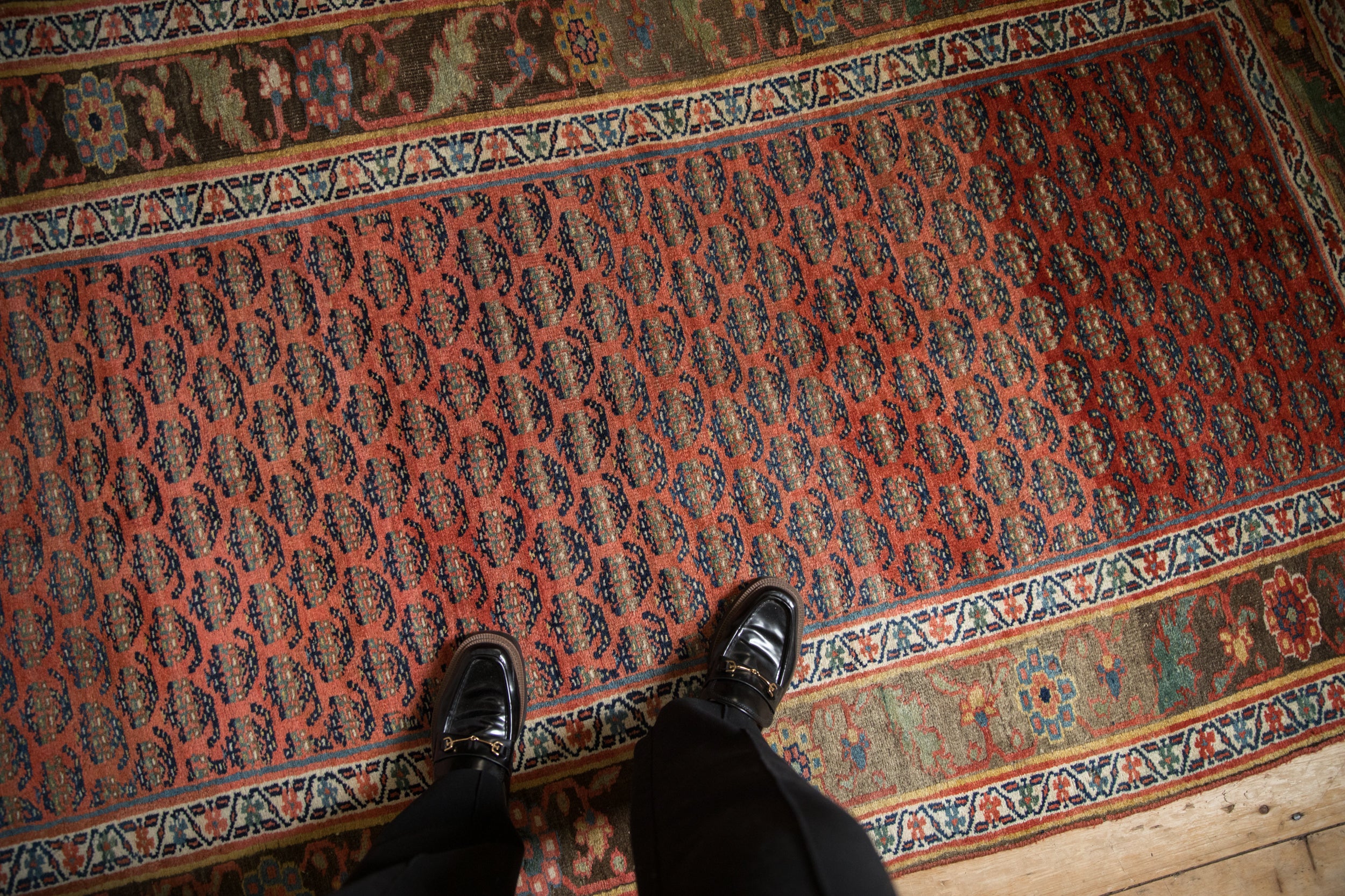 Madder root red staggered boteh field and rich floral border on the antique Persian Bijar runner.