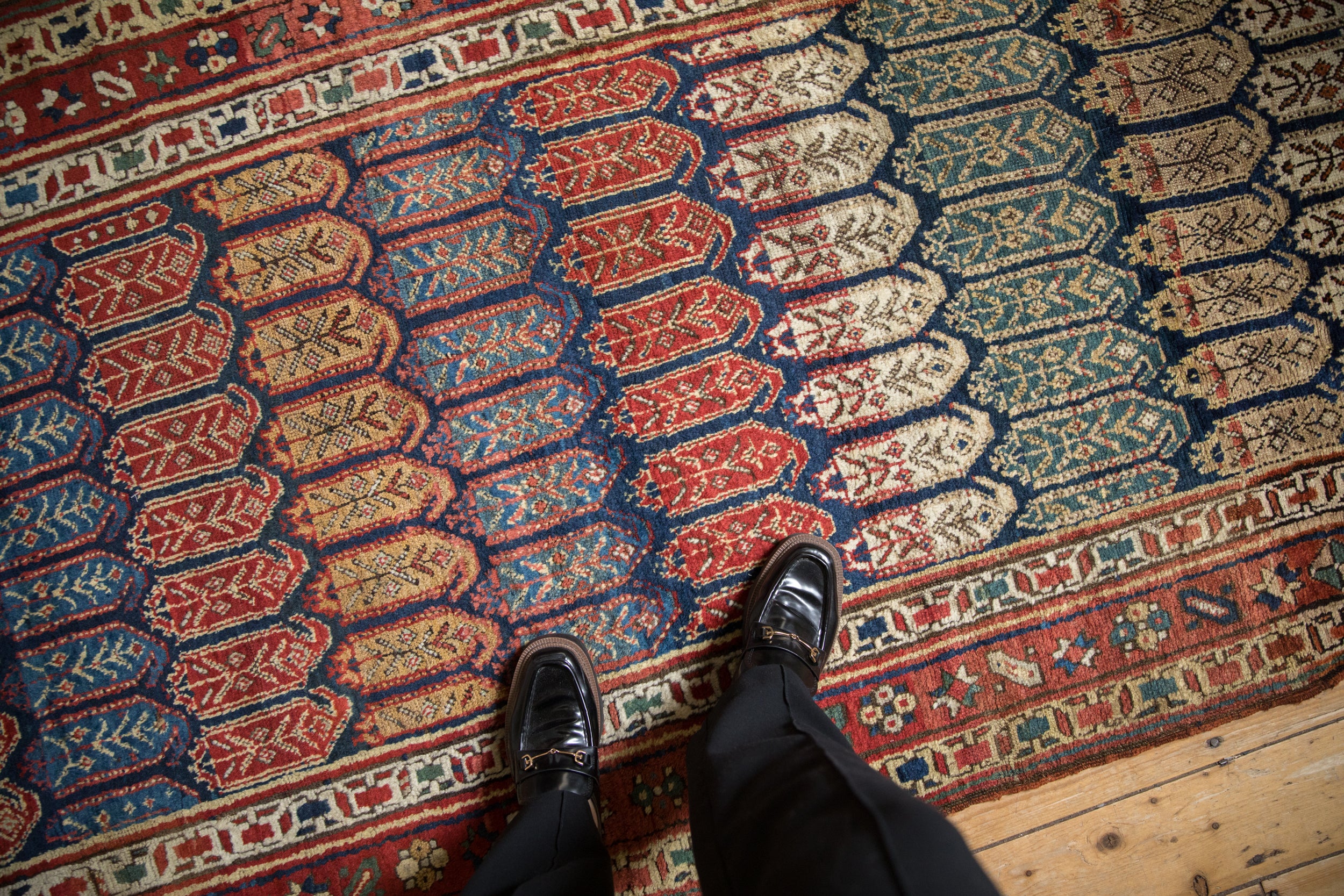 Antique Northwest Persian runner field with staggered botehs showcasing internal germinating plants.