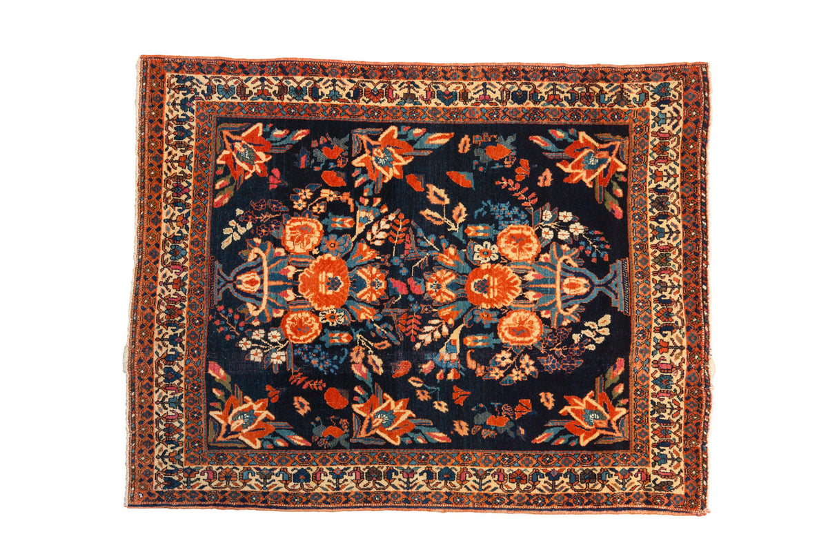 Antique hand-knotted Persian Afshar rug, navy field with dual potted vase and floral motifs.