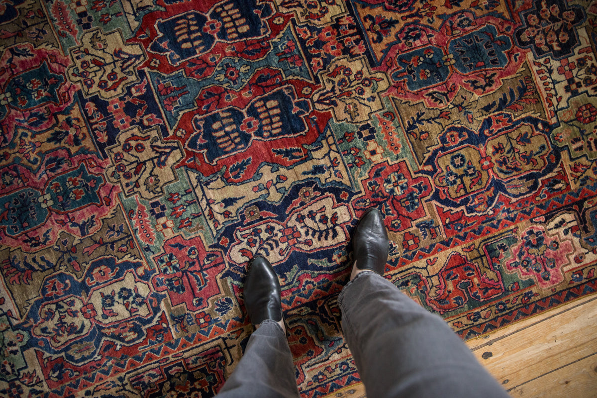 Antique Mohajeran Sarouk carpet detail with reciprocal cartouches in red, navy, beige.