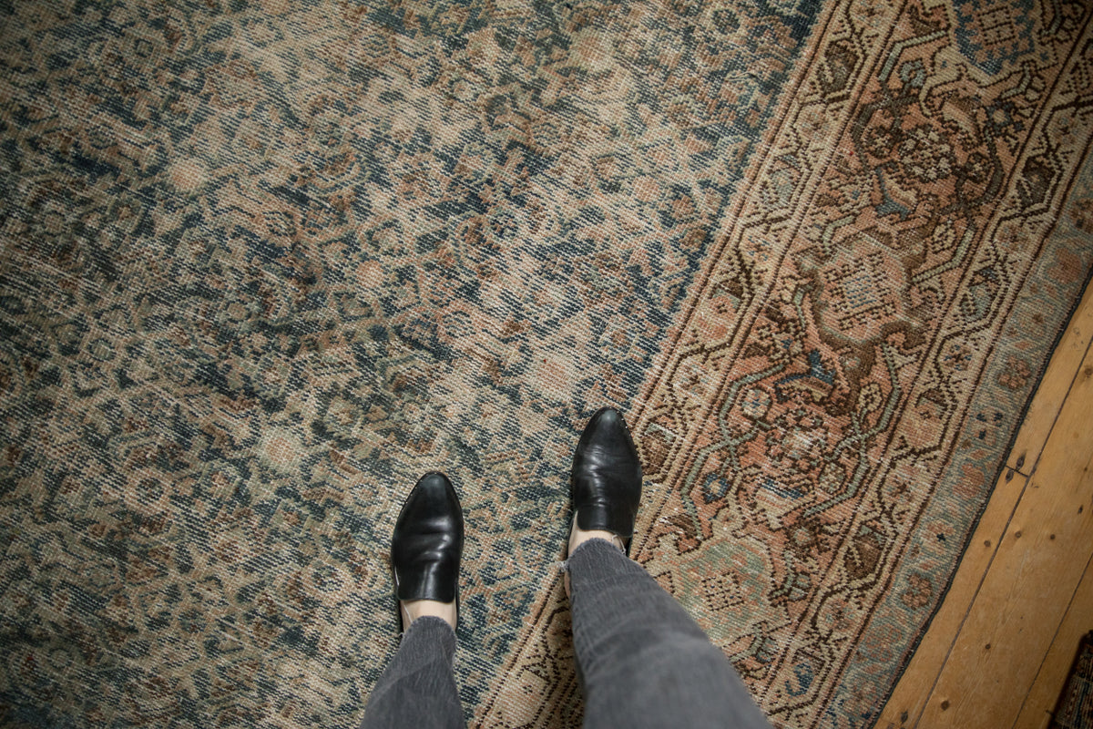 Worn vintage Mahal carpet detail: dusty blue-green Herati field and elaborate border pattern.