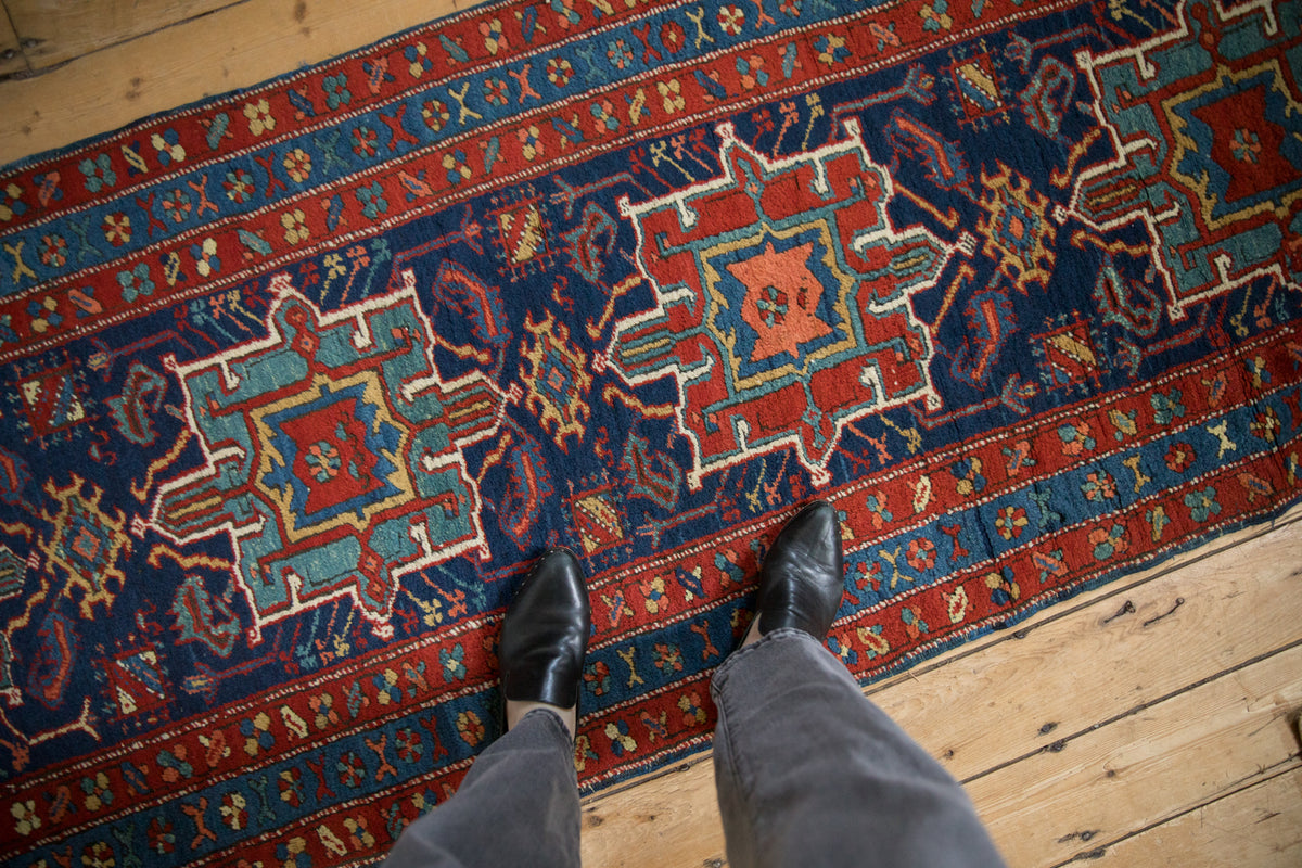 Antique Northwest Persian runner showcasing geometric Karaja-style medallions and patterned barber-pole borders.