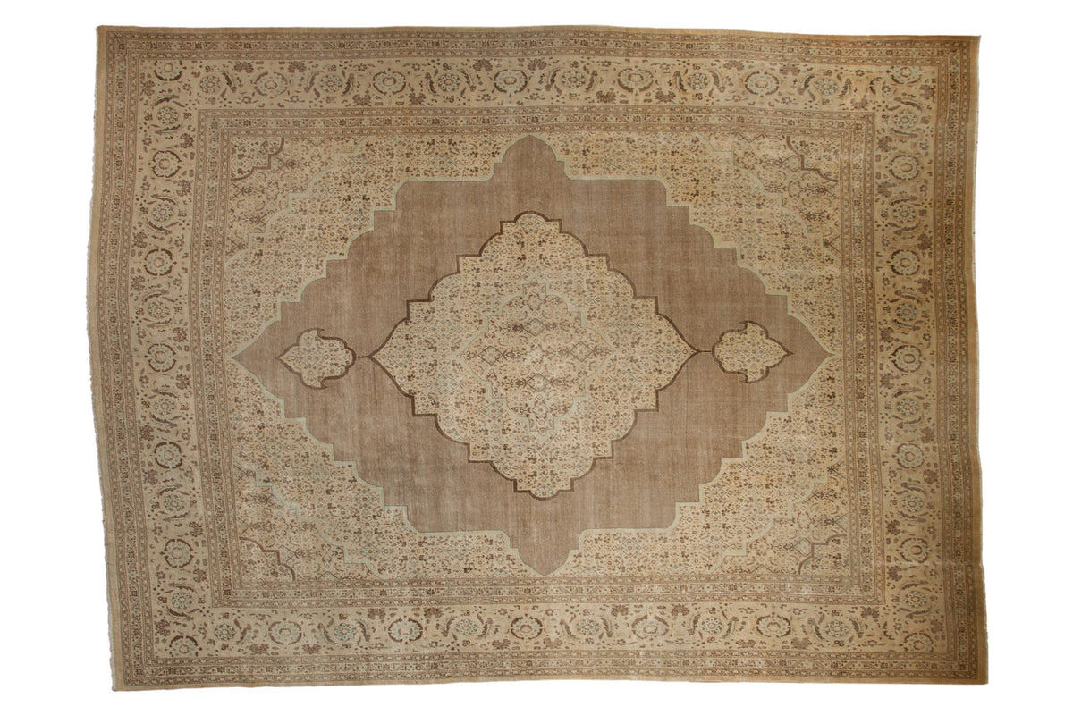 Antique distressed Tabriz carpet with a central Herati medallion, sand, beige, and brown hues.