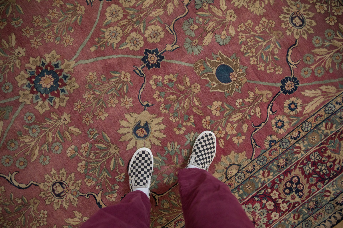 Close-up of antique Kerman carpet: blush field, trefoil floral blossoms, palmette border detail.