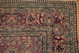 Antique Kerman carpet corner detail, displaying floral bell and palmette borders, cochineal red field.