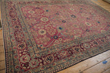 Antique Kerman carpet, blush field with sapphire blue floral vines and cochineal palmette border.