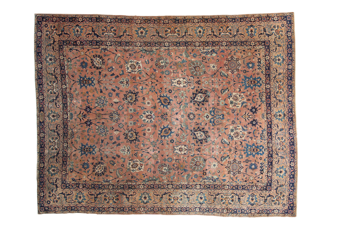 Antique Persian Yazd carpet, dusty apricot field with Safavid floral motifs, navy border.