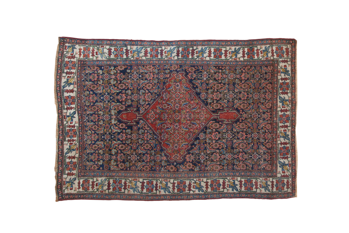 Antique Bijar rug, deep cobalt Herati field, ruby medallion, stylized floral ivory border. 4'7" x 6'9".