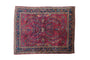 Vintage Lilihan rug, deep red with scrolling palmettes and a navy floral border.