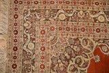 Corner view of an antique Haji Jalili rug's silvery bronze border with lotus flowers.