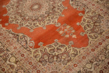 Detail of the ornate medallion and silvery bronze border on an antique Haji Jalili Tabriz rug.