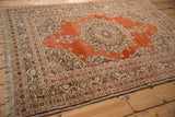 Corner of an antique Haji Jalili rug with a silvery bronze border of lotus flowers and serpents.