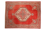 Distressed Oushak carpet with a large geometric medallion and corner spandrels on a cherry red field.