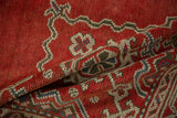 Softly folded distressed Oushak carpet highlighting the hand-knotted texture in cherry red and ivory.