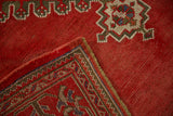 The reverse weave and hand-knotted foundation of a vintage cherry red Turkish Oushak rug.