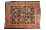 Vintage Mahal carpet with a navy blue field, geometric lattice medallions, and a terracotta rust border.