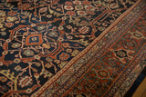 Detailed view of the vintage Mahal carpet's classic turtle samovar border.