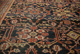 Low-pile texture of a vintage Mahal carpet showing knot heads amid geometric vinery in rust and navy.