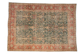 Distressed Tabriz carpet with a floral vase lattice design on a green field and a bold red border.