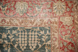 Worn hand-knotted pile of a vintage Tabriz revealing its foundation and floral motifs.