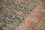 Angled detail of a vintage distressed Tabriz showing low pile texture over its floral lattice design.